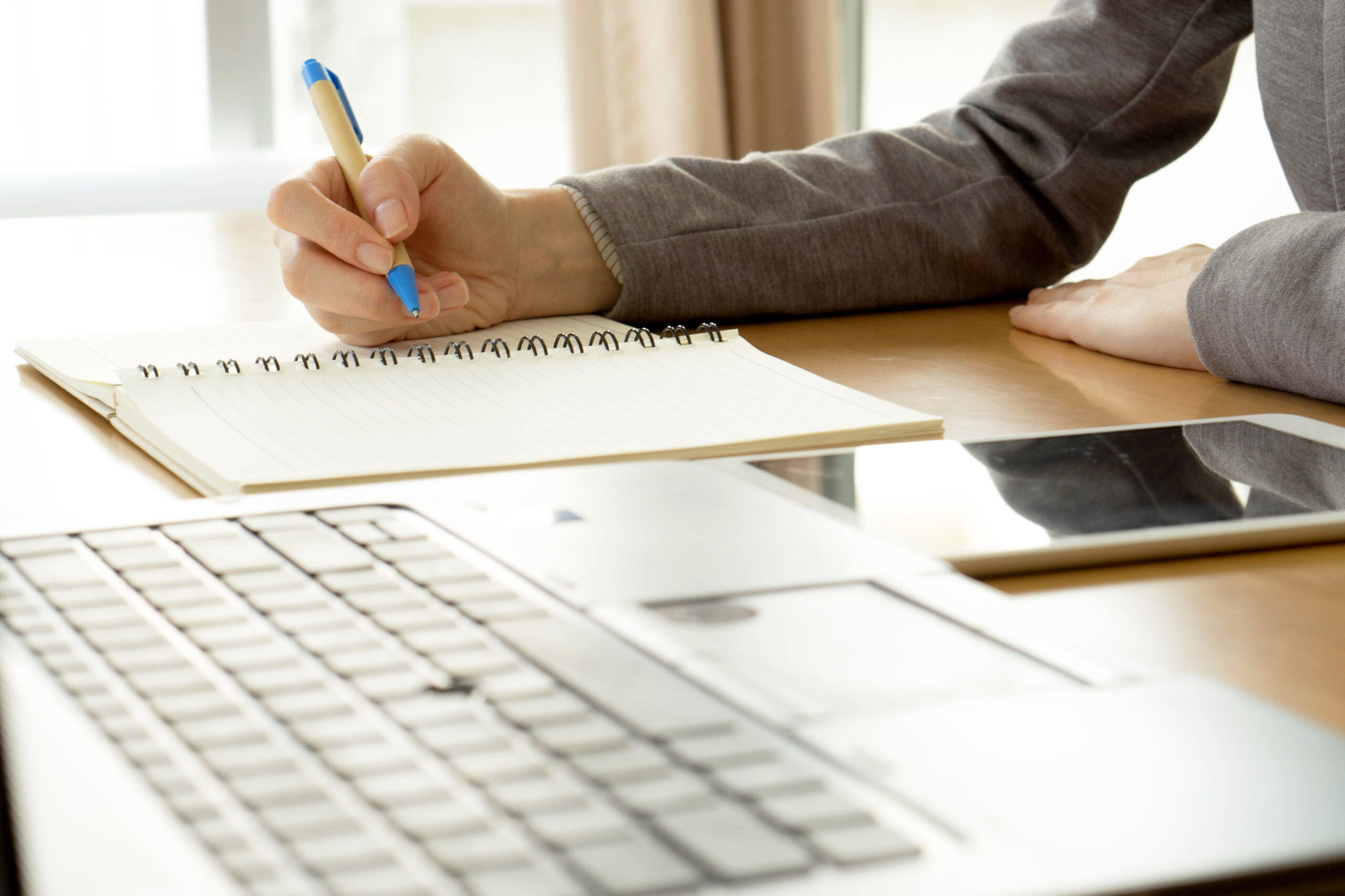 A content creator working on writing at a desk